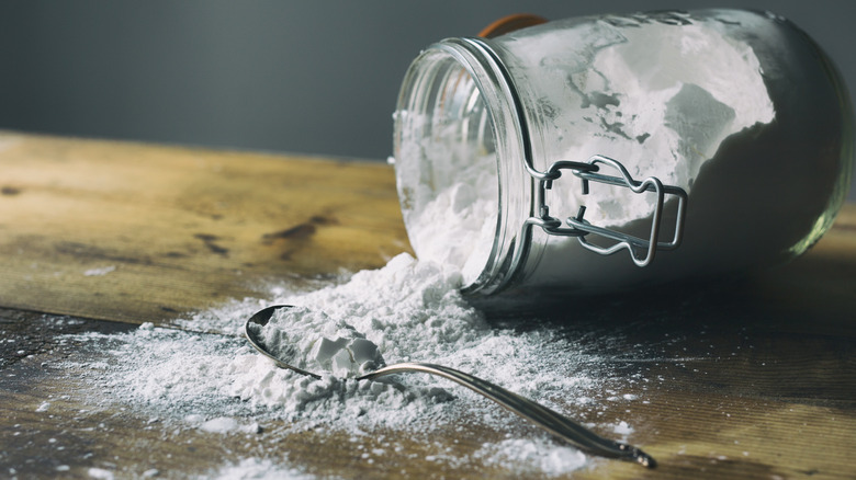 A glass jar turned sideways with arrowroot powder