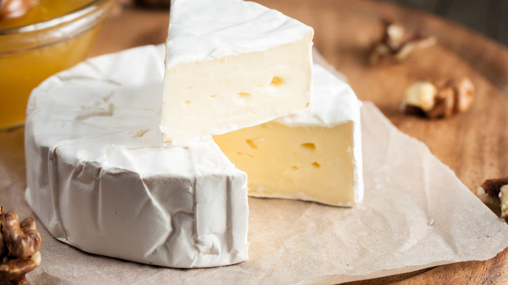 A circle and a wedge of brie cheese