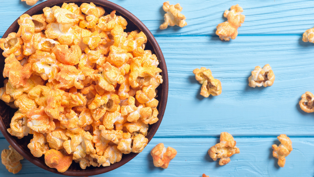 Cheesy popcorn against a blue background