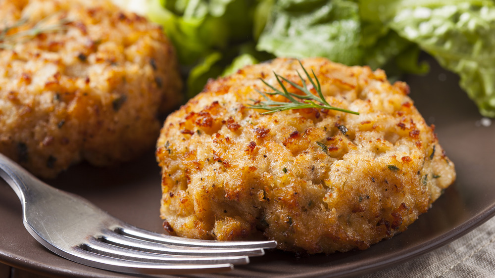 plate of crab cakes with herb garnish