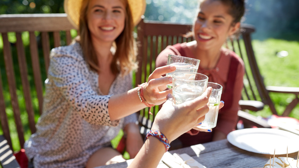 Women clinking their cocktail glasses together