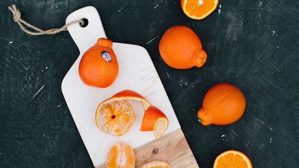 Sunkist citrus fruits on cutting board