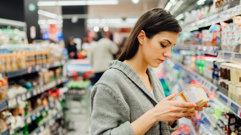 Shopper reads a food label