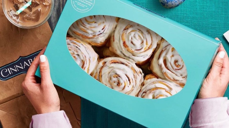 Person holding Cinnabon box