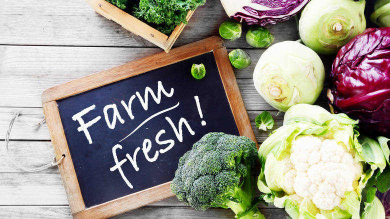 Bunch of vegetables next to sign that says Farm Fresh