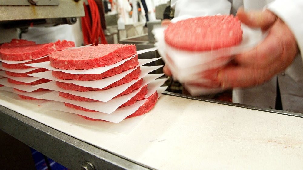 Ground beef patties being proceessed