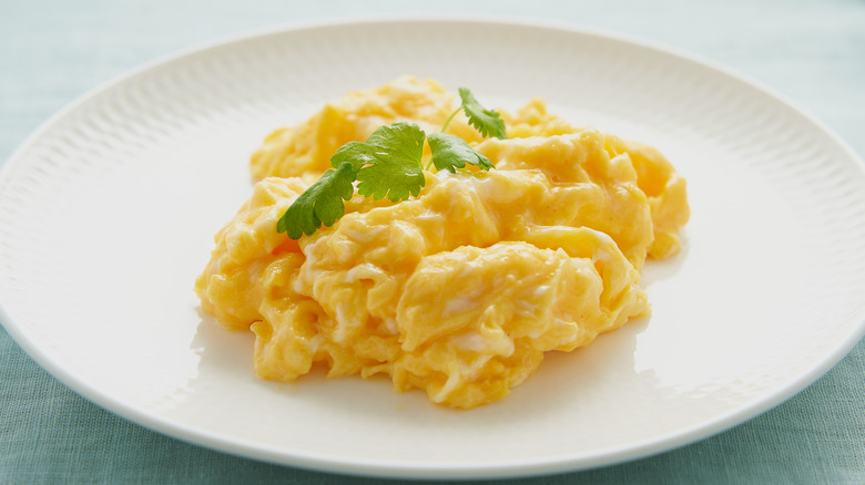 Plate of scrambled eggs with herbs