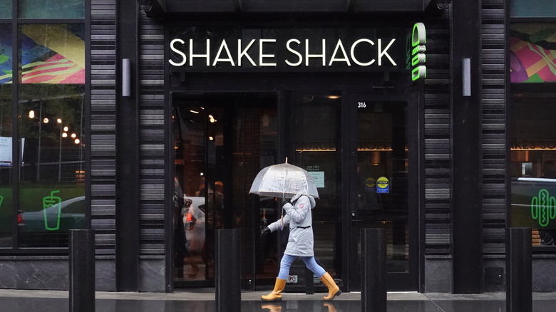 Woman walking past Shake Shack 