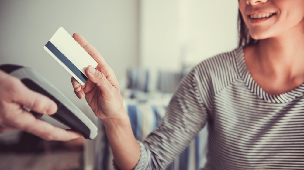 Woman making purchase with credit card