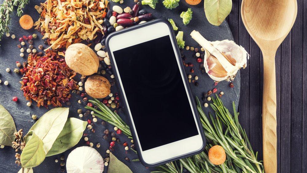 phone with table full of groceries