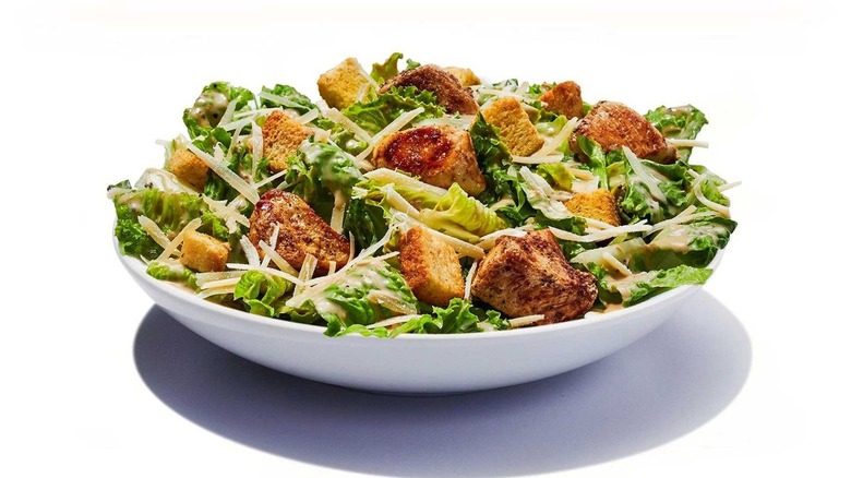 grilled chicken caesar salad with croutons and cheese