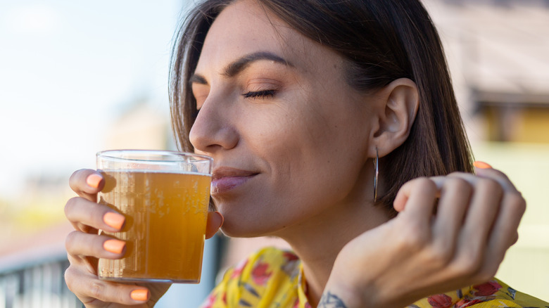 happy woman sipping kombucha