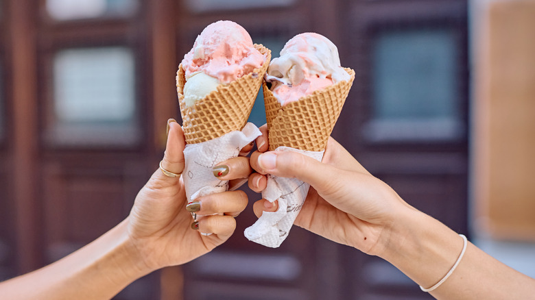 Two people with gelato ice cream in a waffle cone