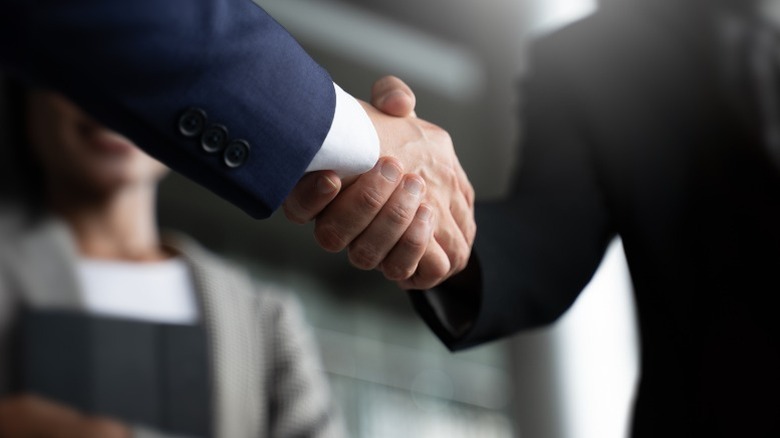 Two people shake hands