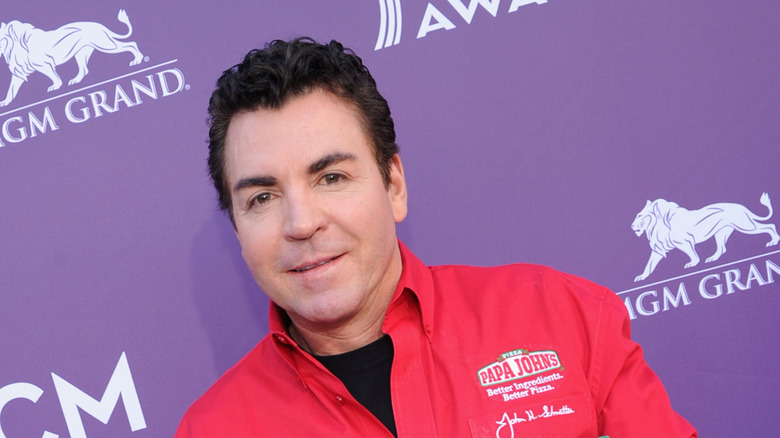 John Schnatter with red shirt and purple background