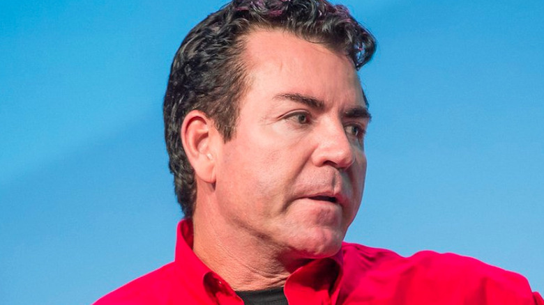 John Schnatter wearing red Papa John's shirt