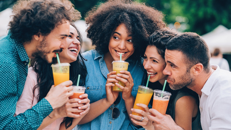 Happy people drinking smoothies
