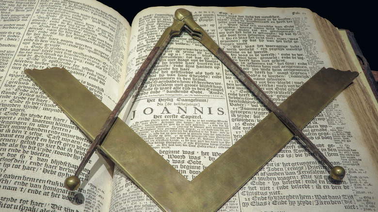Masonic symbol sits on top of a bible.