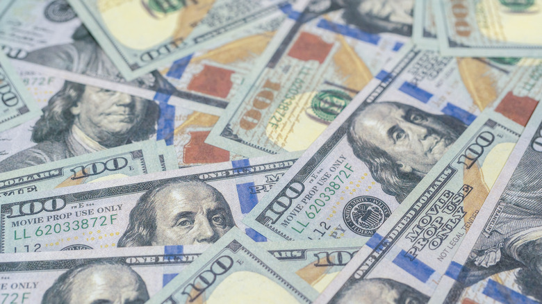 Several $100 bills spread out.