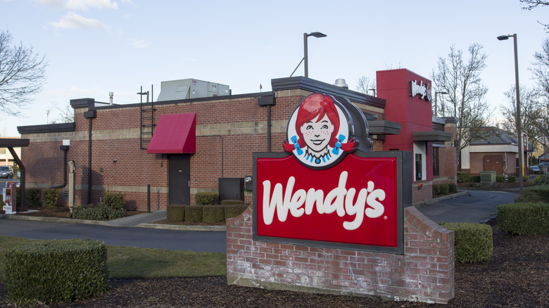 Wendy's sign in front of a Wendy's restaurant.