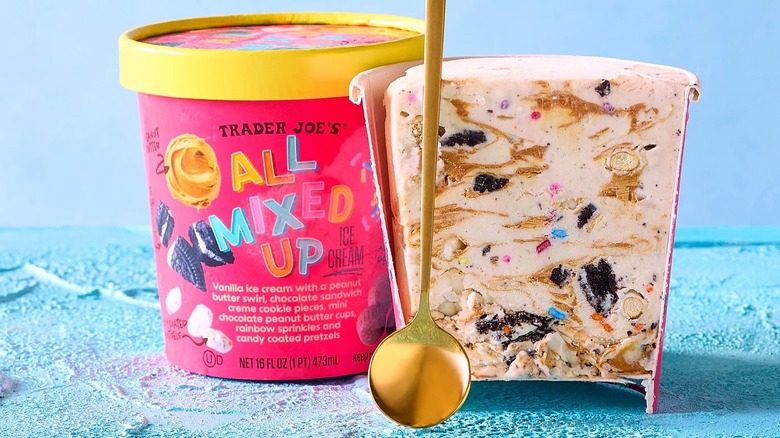 Trader Joe's All Mixed Up ice cream pint with golden spoon and section cut of what the treat looks like