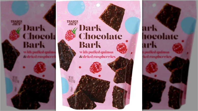 Package of dark chocolate candy bark with puffed quinoa and dried raspberries.