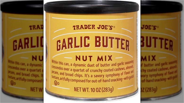 Container with garlic butter flavored snack mix with cashews, almonds, pecans, and bread chips.