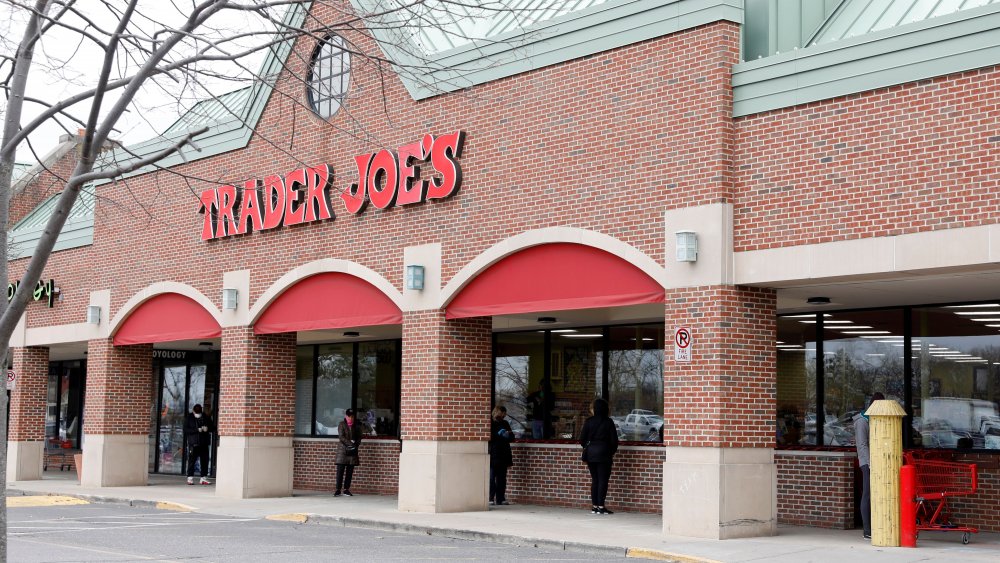 Shoppers wait outside Trader Joe's with social distancing