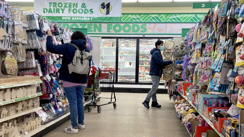 Shoppers in Dollar Tree aisles 