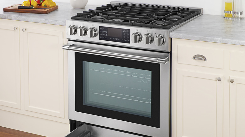 An oven fits between kitchen cabinets.