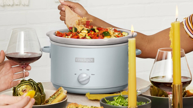 Crock-Pot full of food on table.