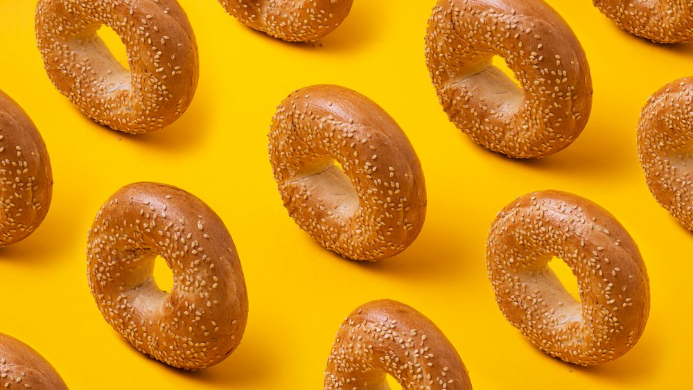 Sesame bagels against a yellow background
