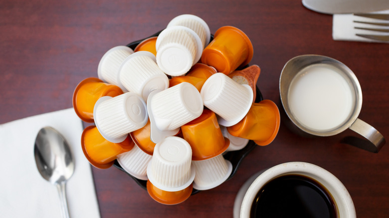 Creamer packets next to coffee and cream