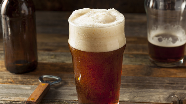 Frothy amber ale in a pint glass