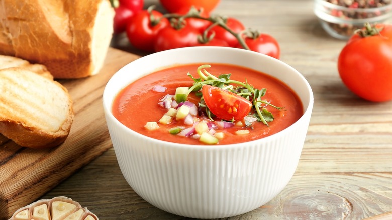Bowl of gazpacho with tomatoes and bread