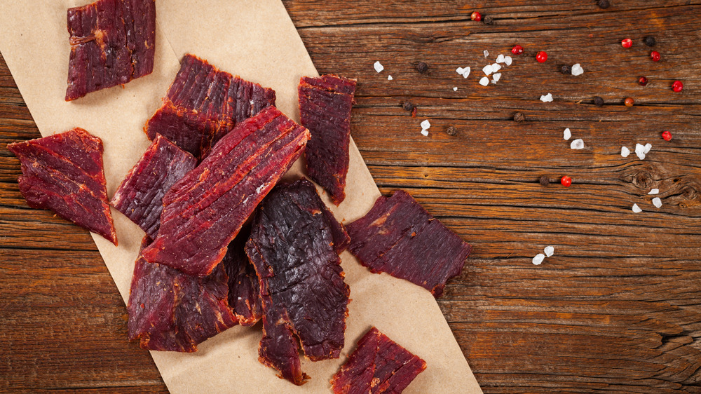 pieces of beef jerky on wood background