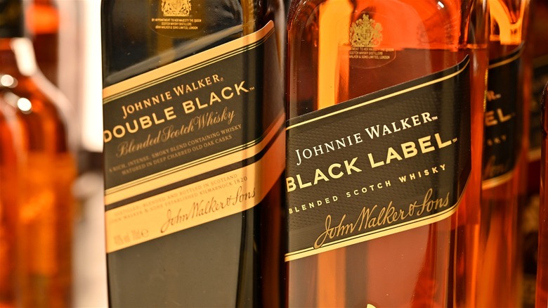 Bottles of Johnnie Walker Double Black and Black Label displayed next to each other.