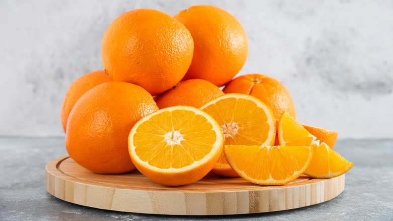 Pile of oranges on cutting board