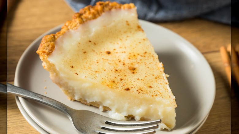 slice of sugar cream pie on a plate with a fork