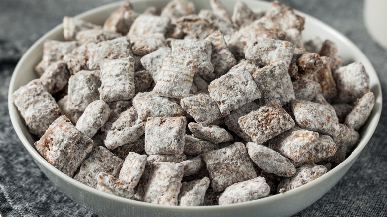 bowl of puppy chow on a gray cloth