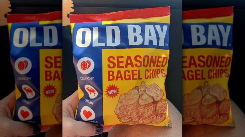 hand holding a bag of Old Bay seasoned bagel chips