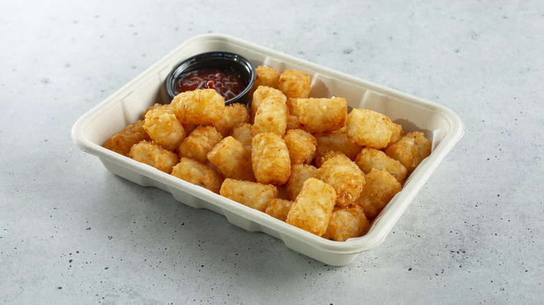 carton of Tater Tots with ketchup on the side