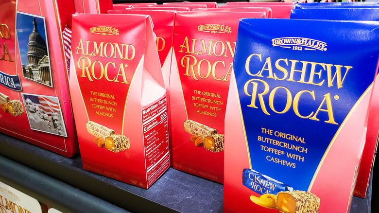 shelf holding several packages of Almond Roca and Cashew Roca