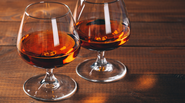 Two glasses of brandy on table