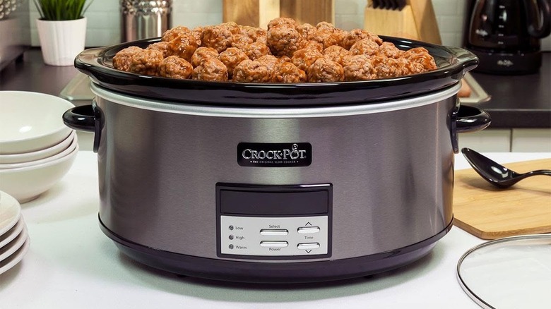 Mountain of meatballs in Crock-Pot on kitchen counter.