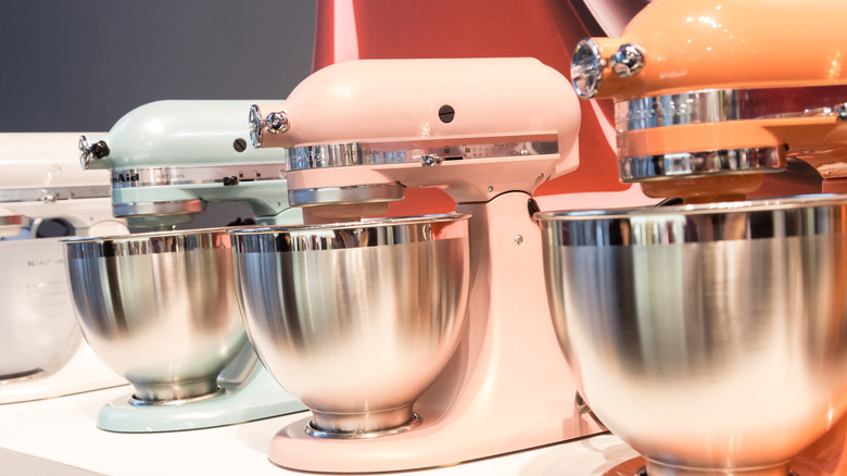 Four different colors of KitchenAid stand mixers lined up