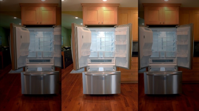 A refrigerator with doors open inside a home kitchen