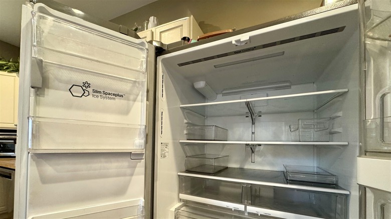 Malfunctioning LG refrigerator with doors open.