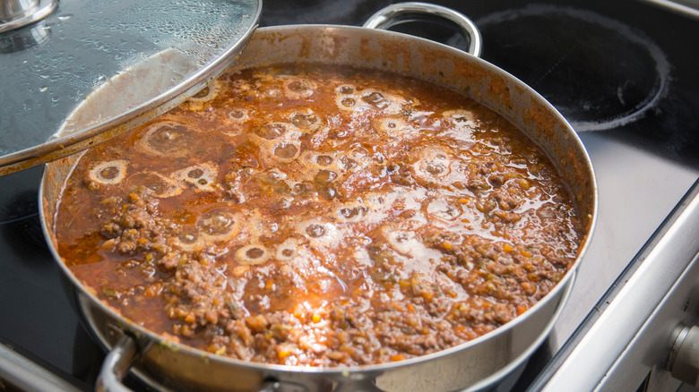 bolognese sauce bubbling in pot