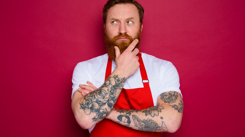 tattooed chef thinking